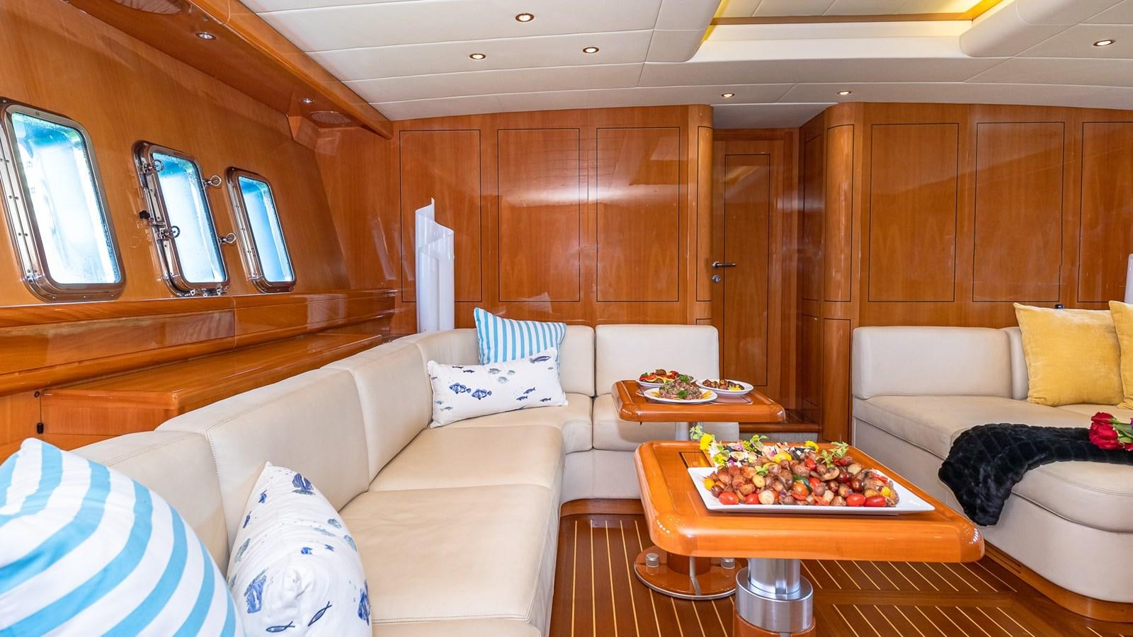 a living room with a couch and a table aboard HAPPY Yacht for Sale