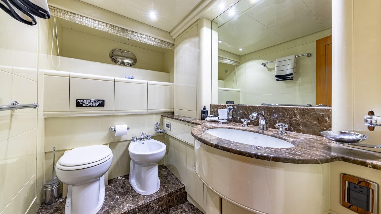 a bathroom with a large mirror aboard HAPPY Yacht for Sale