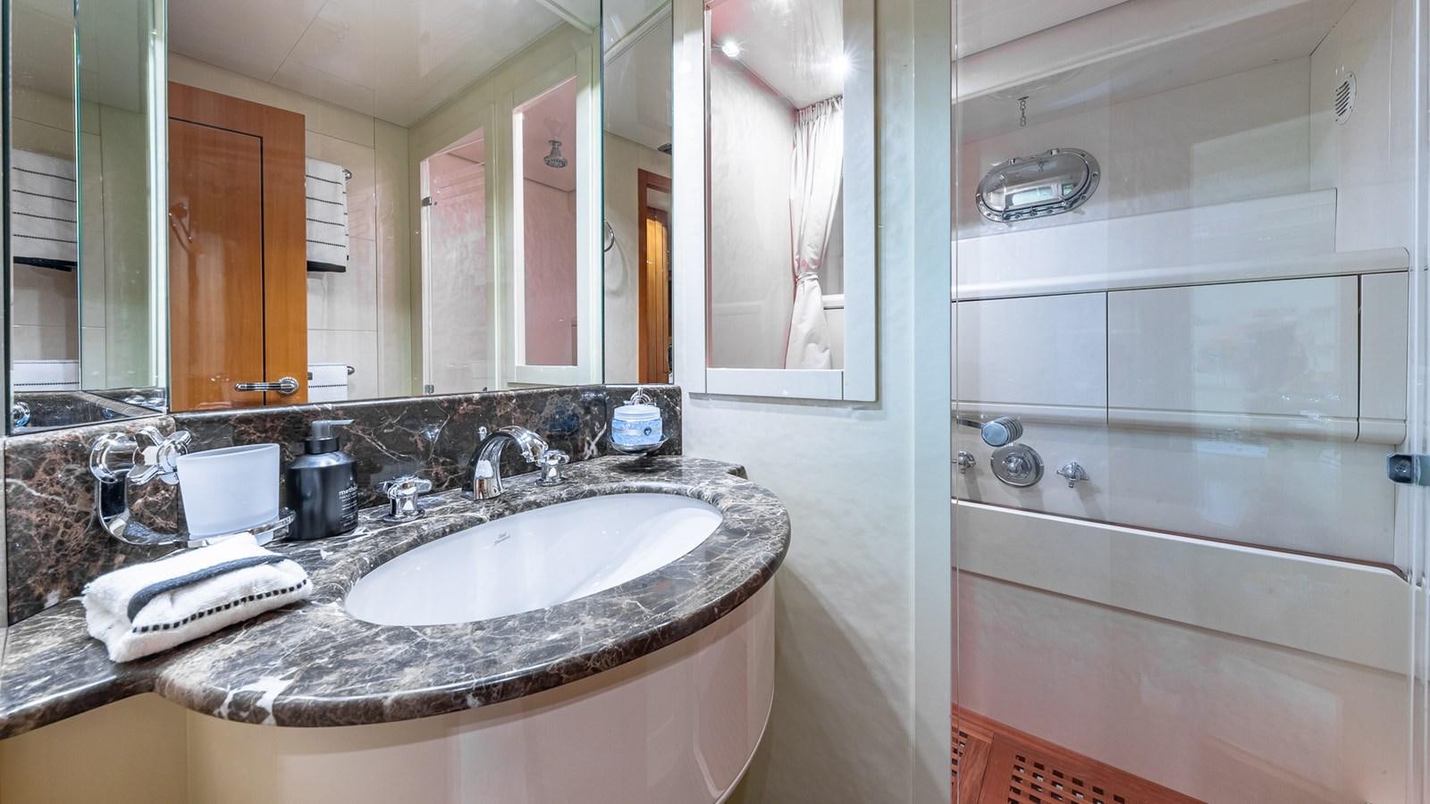 a bathroom with a sink and a mirror aboard HAPPY Yacht for Sale