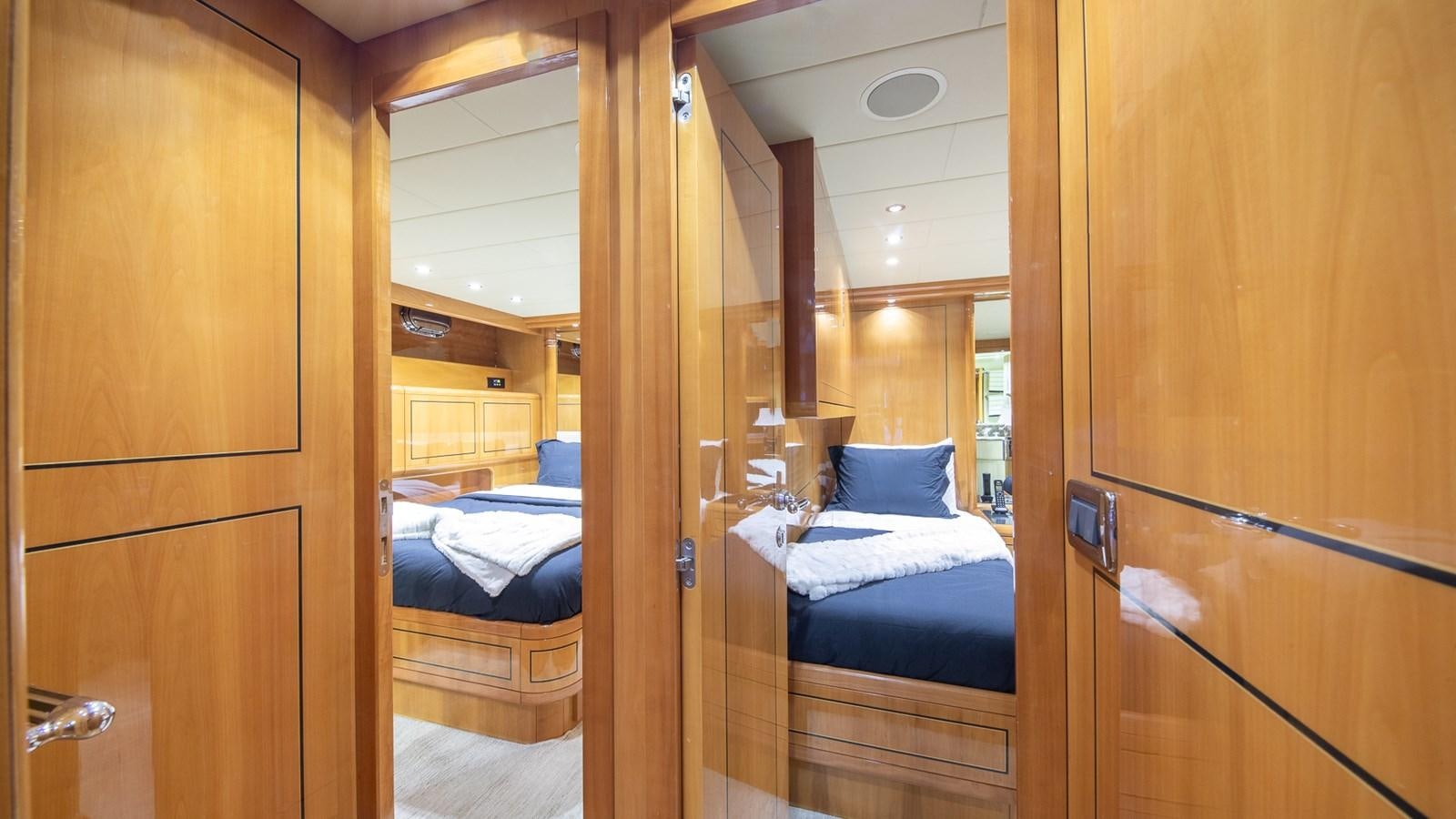 a room with a bed and a closet aboard HAPPY Yacht for Sale