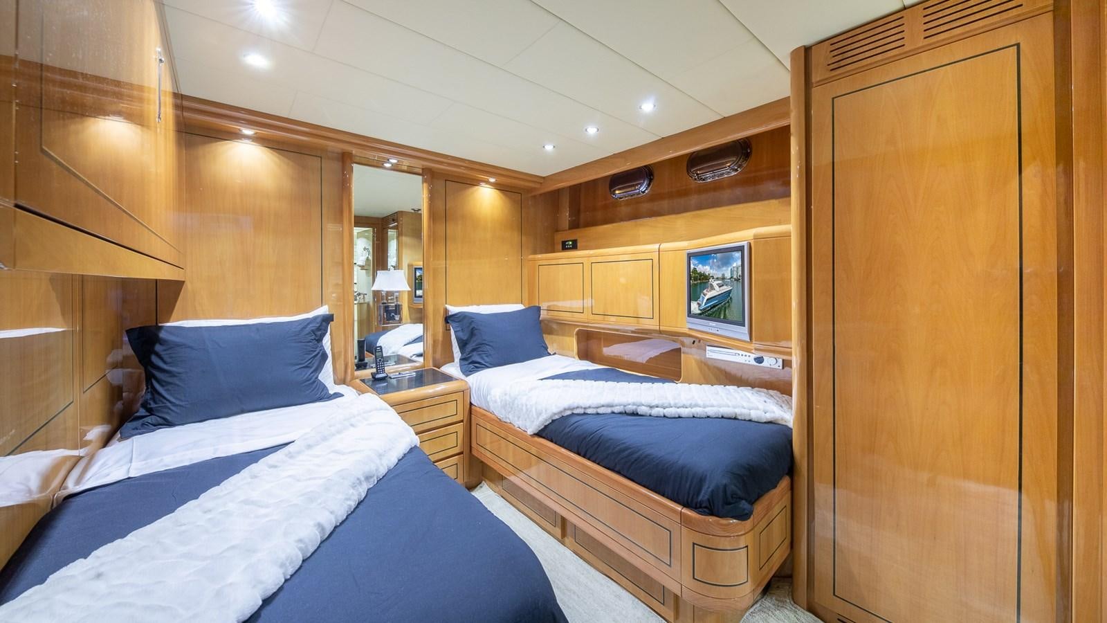a room with a bed and a mirror aboard HAPPY Yacht for Sale