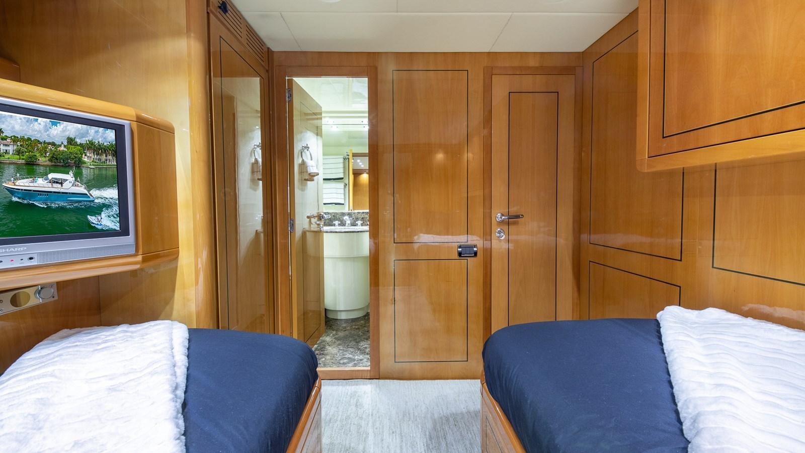 a room with a bed and a television aboard HAPPY Yacht for Sale