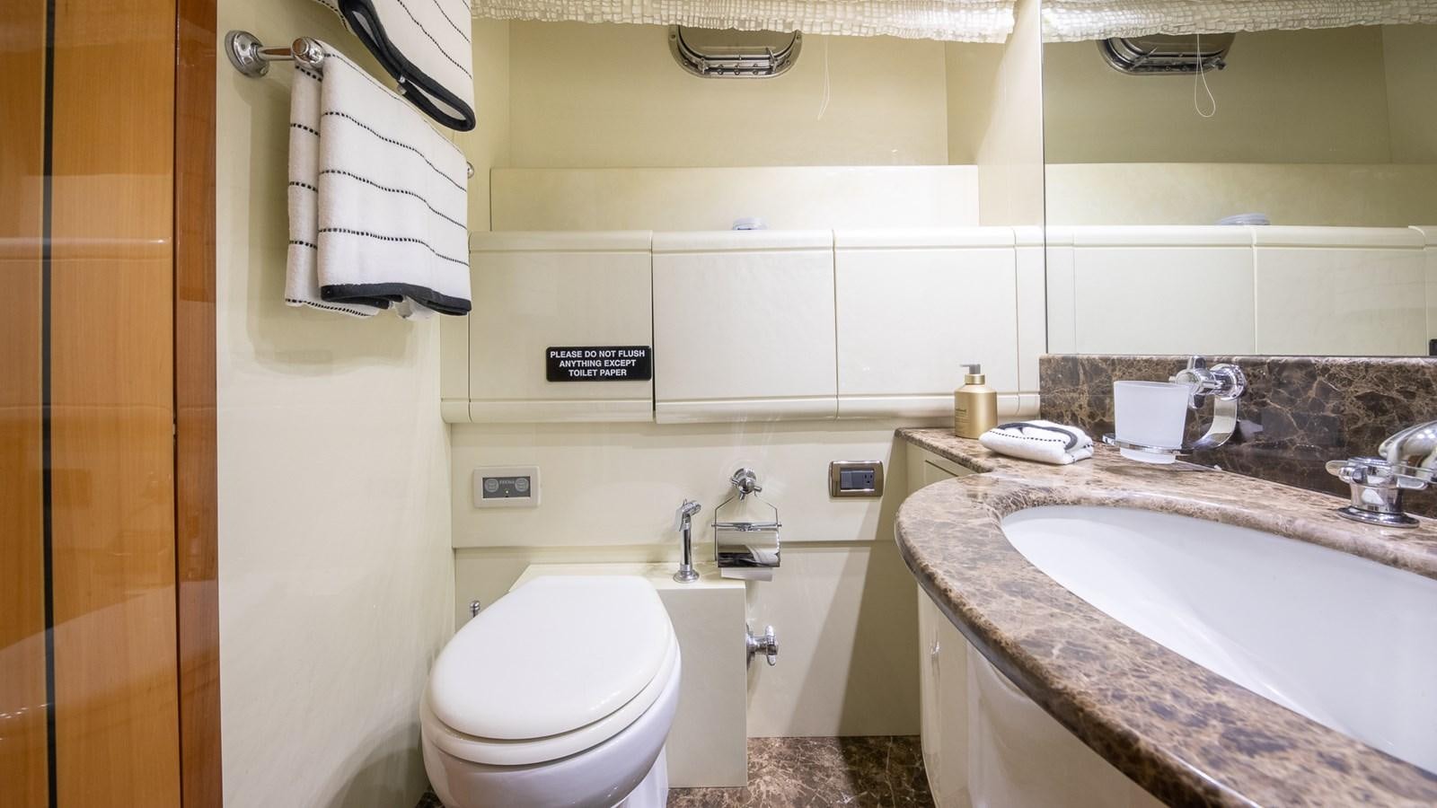 a bathroom with a sink toilet and a bathtub aboard HAPPY Yacht for Sale