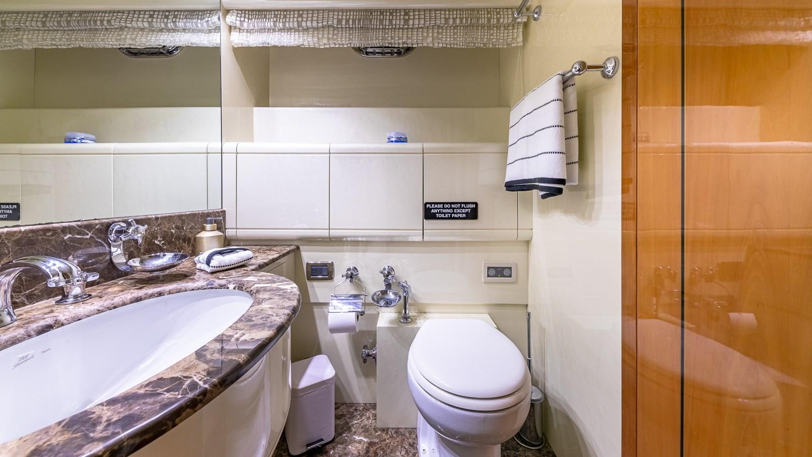 a bathroom with a sink toilet and a bathtub aboard HAPPY Yacht for Sale
