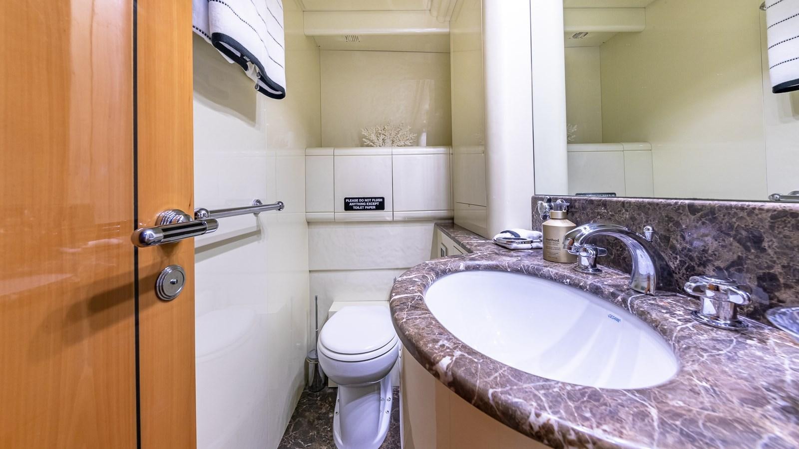 a bathroom with a sink and a toilet aboard HAPPY Yacht for Sale