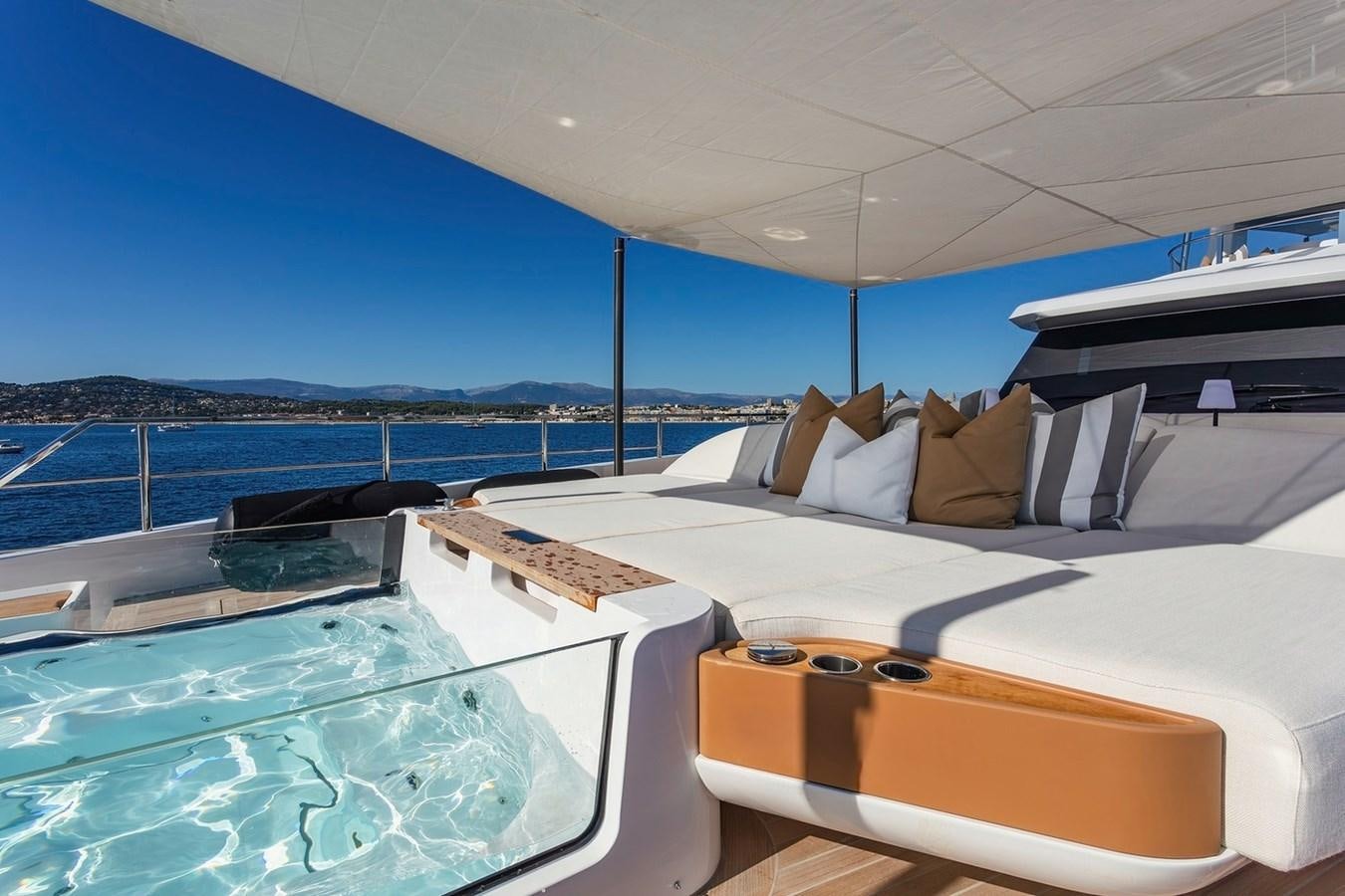 a pool with a deck and a view of the water aboard ADELLA Yacht for Sale