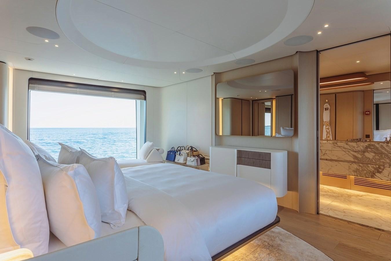 a bedroom with a large bed aboard ADELLA Yacht for Sale