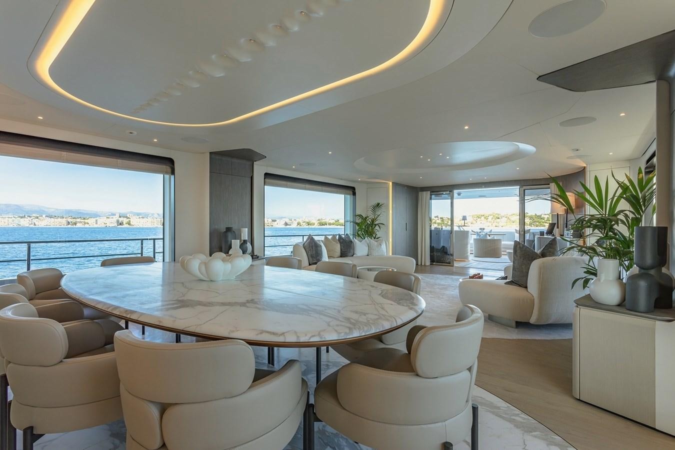 a large living room with a large table and chairs aboard ADELLA Yacht for Sale