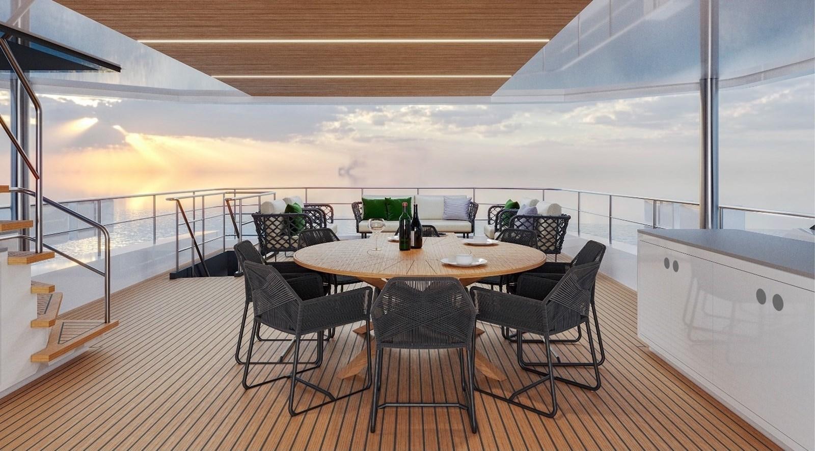 a table with chairs and a laptop on it aboard AVENTURA 130 Yacht for Sale