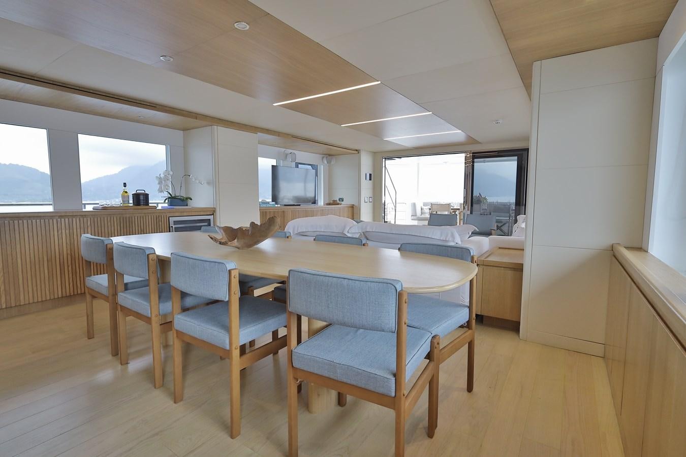 a large room with a table and chairs aboard WAIKIKI Yacht for Sale