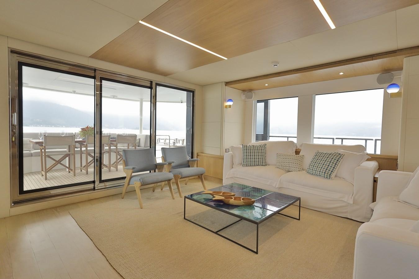 a living room with a couch and a table aboard WAIKIKI Yacht for Sale