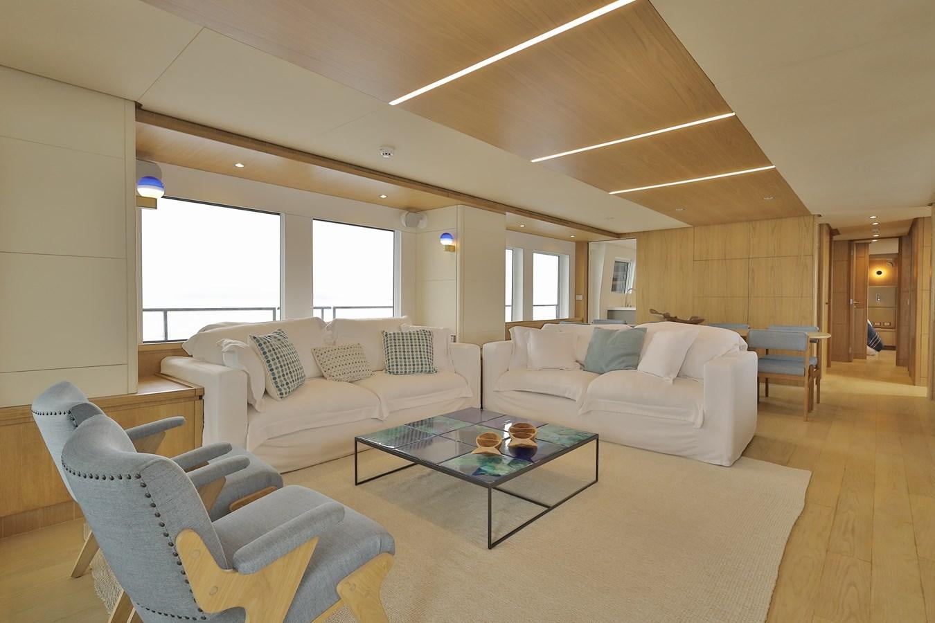 a living room with a couch and a coffee table aboard WAIKIKI Yacht for Sale