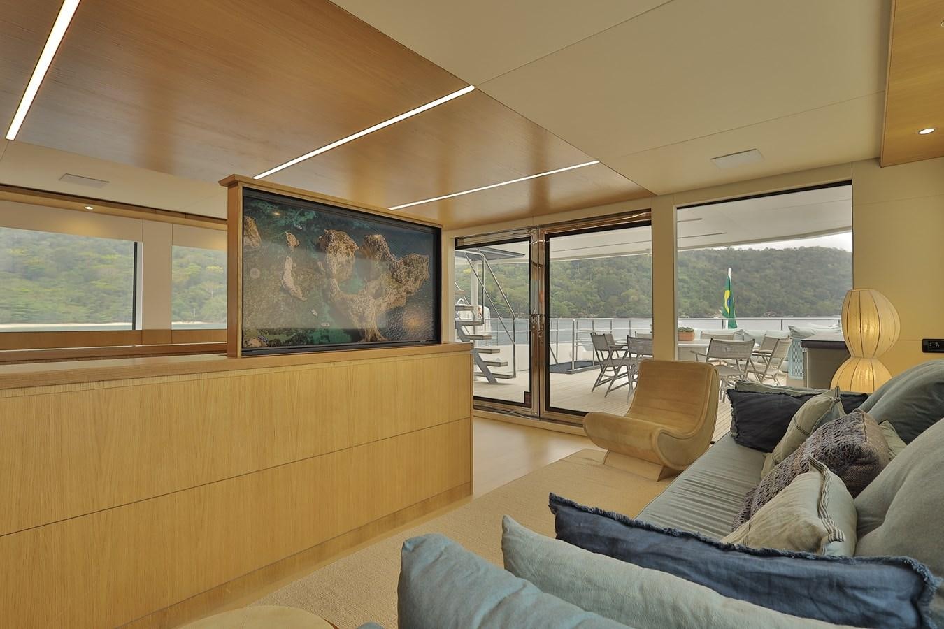 a living room with a large window aboard WAIKIKI Yacht for Sale