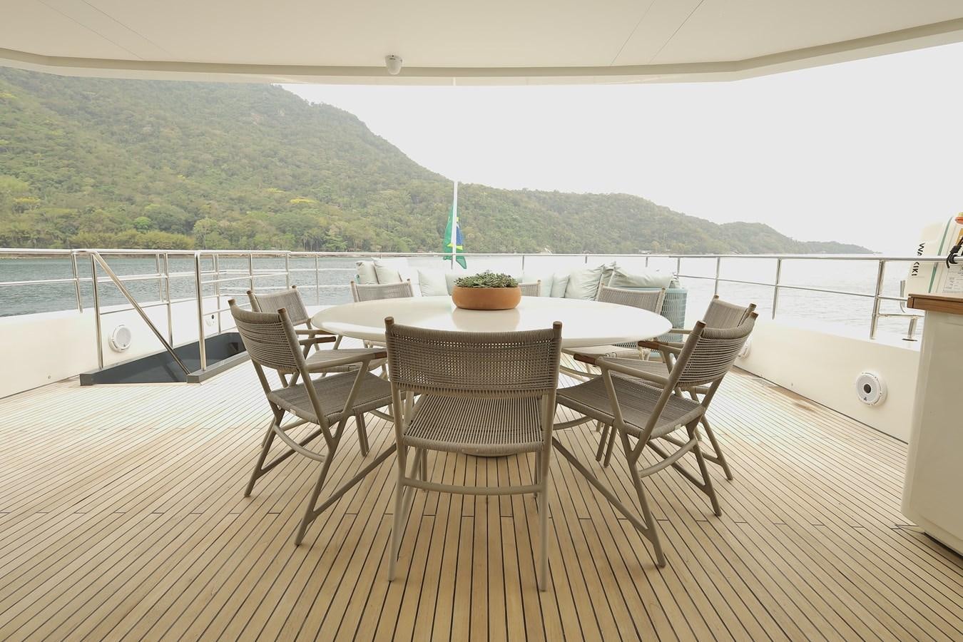 a table and chairs on a deck aboard WAIKIKI Yacht for Sale