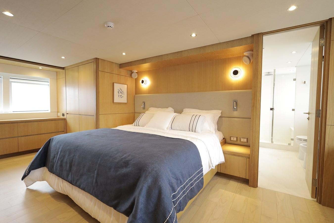 a bedroom with a bed aboard WAIKIKI Yacht for Sale