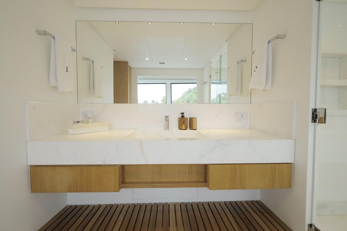a bathroom with a sink and a mirror aboard WAIKIKI Yacht for Sale