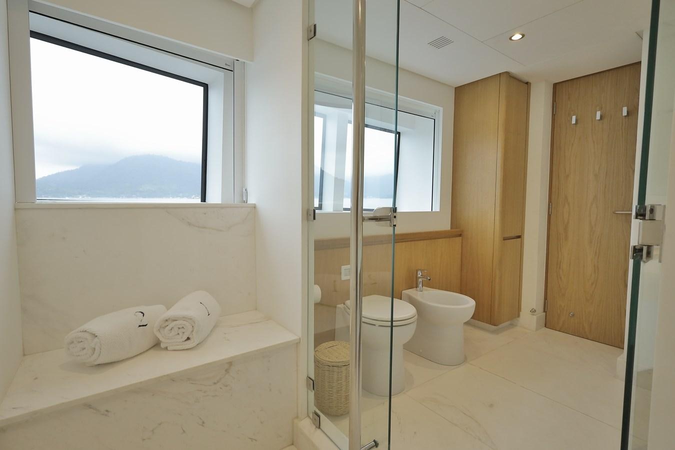 a bathroom with a tub sink and toilet aboard WAIKIKI Yacht for Sale