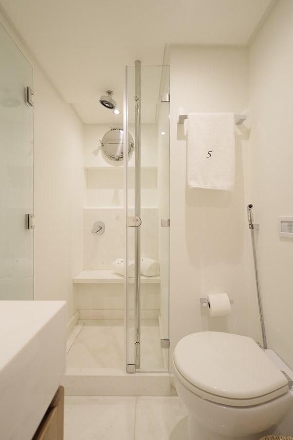 a bathroom with a stand up shower aboard WAIKIKI Yacht for Sale