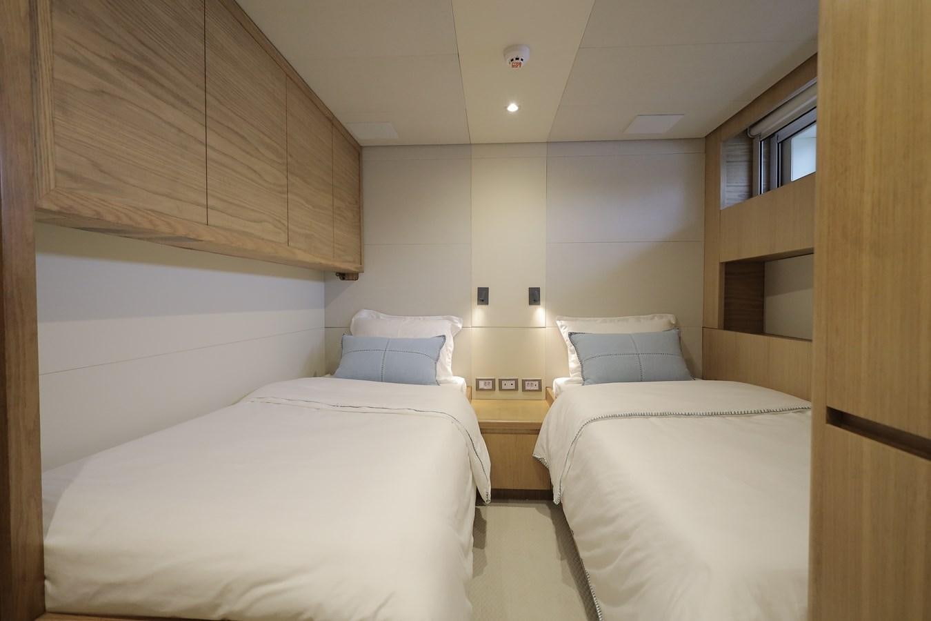 a room with two beds aboard WAIKIKI Yacht for Sale