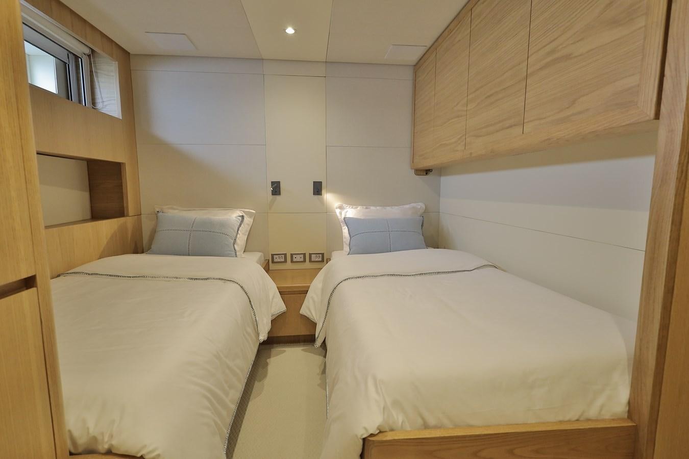 a room with two beds aboard WAIKIKI Yacht for Sale