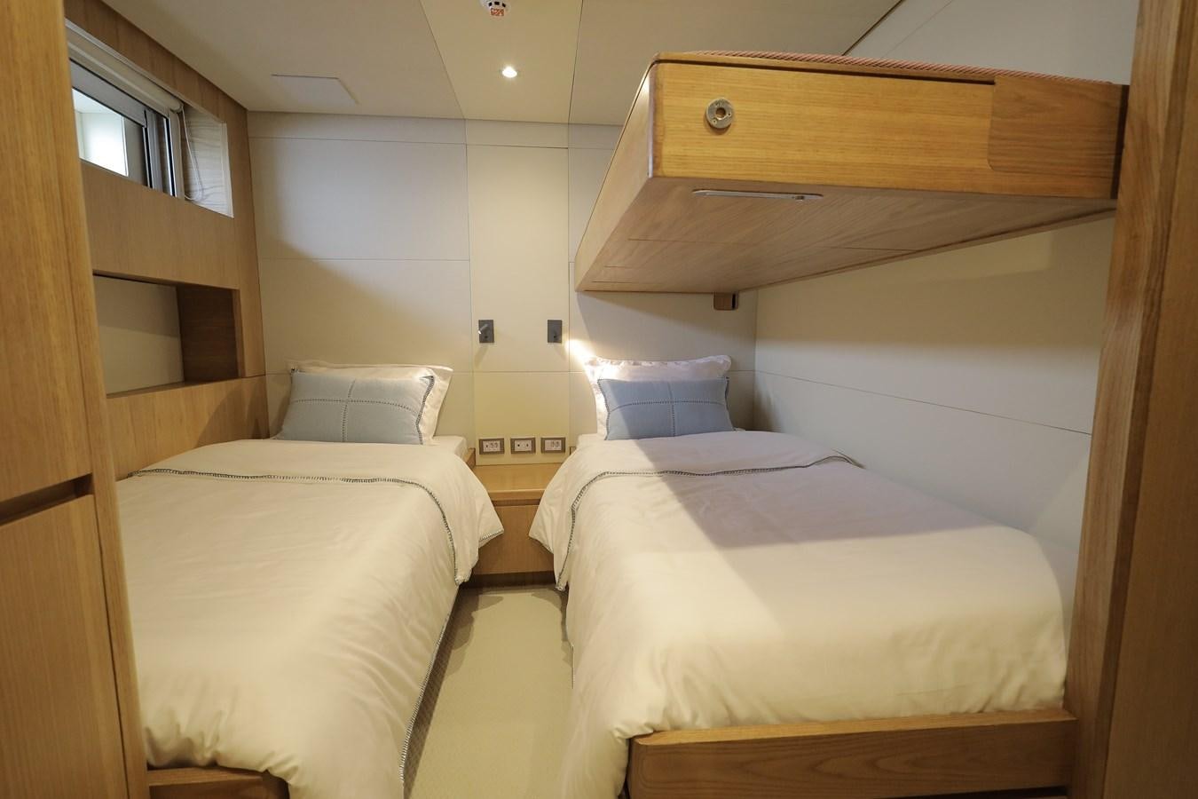 a room with two beds aboard WAIKIKI Yacht for Sale