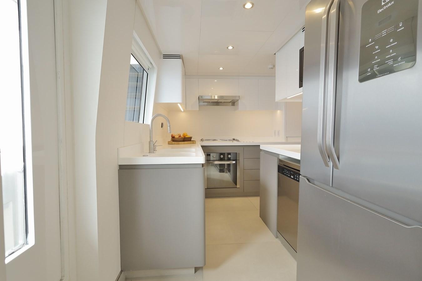a kitchen with white appliances aboard WAIKIKI Yacht for Sale