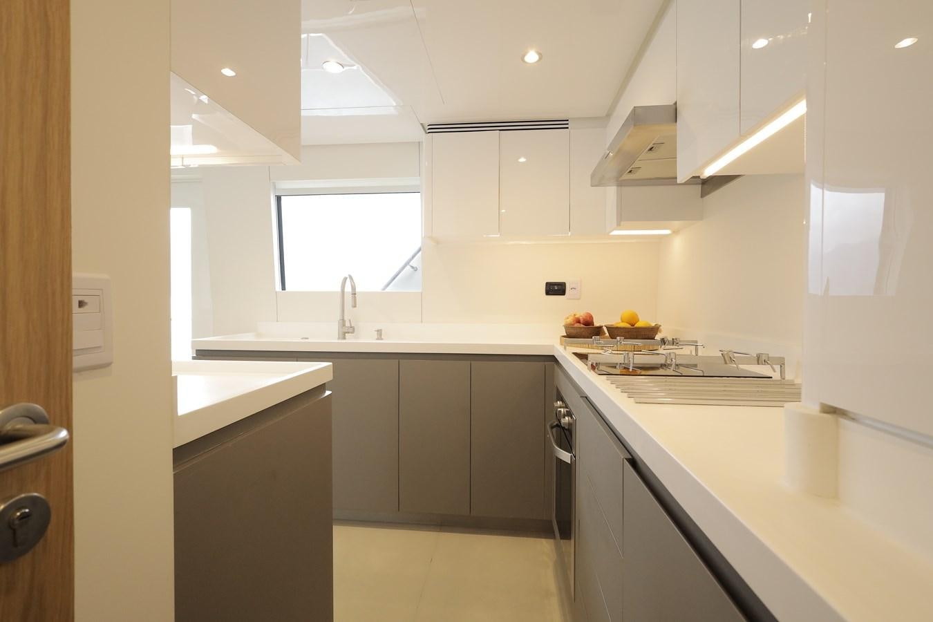 a kitchen with white cabinets aboard WAIKIKI Yacht for Sale