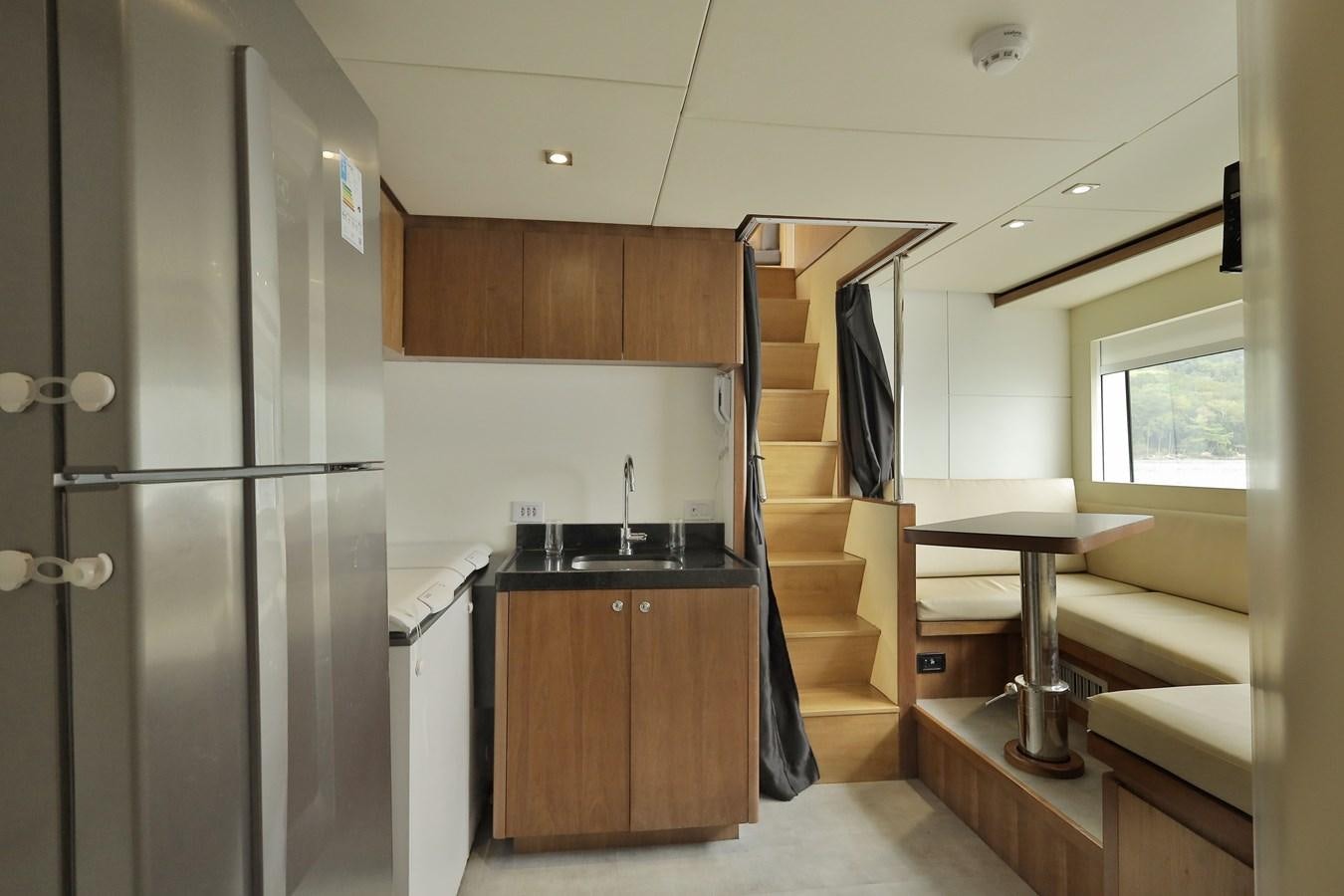 a kitchen with a fridge and a sink aboard WAIKIKI Yacht for Sale