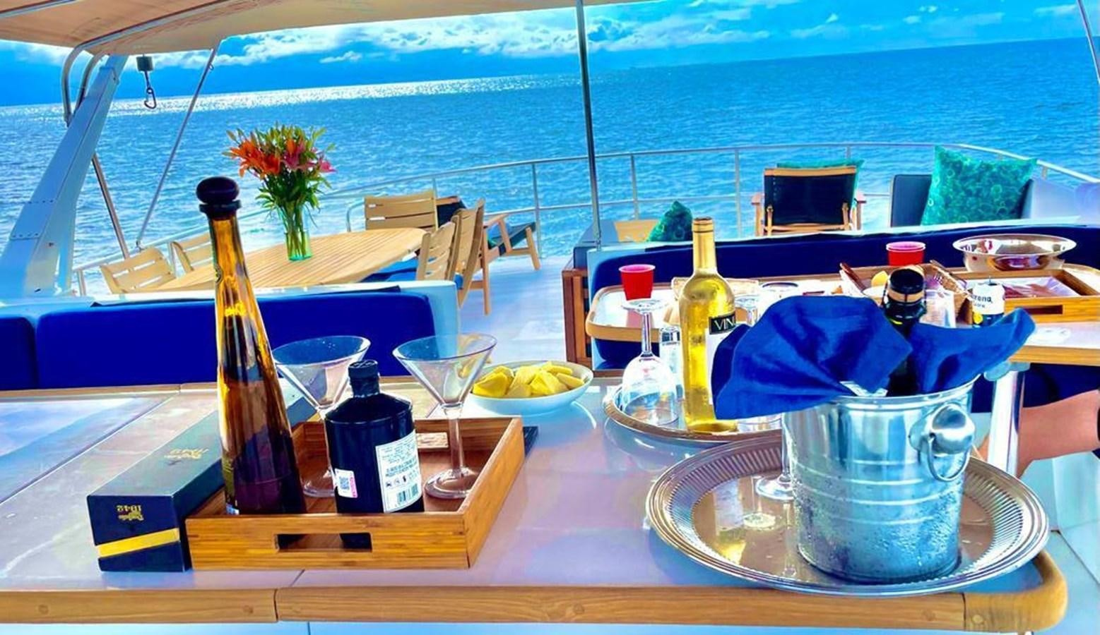 a table with food and drinks on it aboard A NEW BEGINNING Yacht for Sale