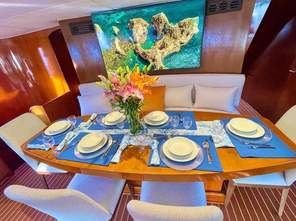 a table with plates and flowers aboard A NEW BEGINNING Yacht for Sale