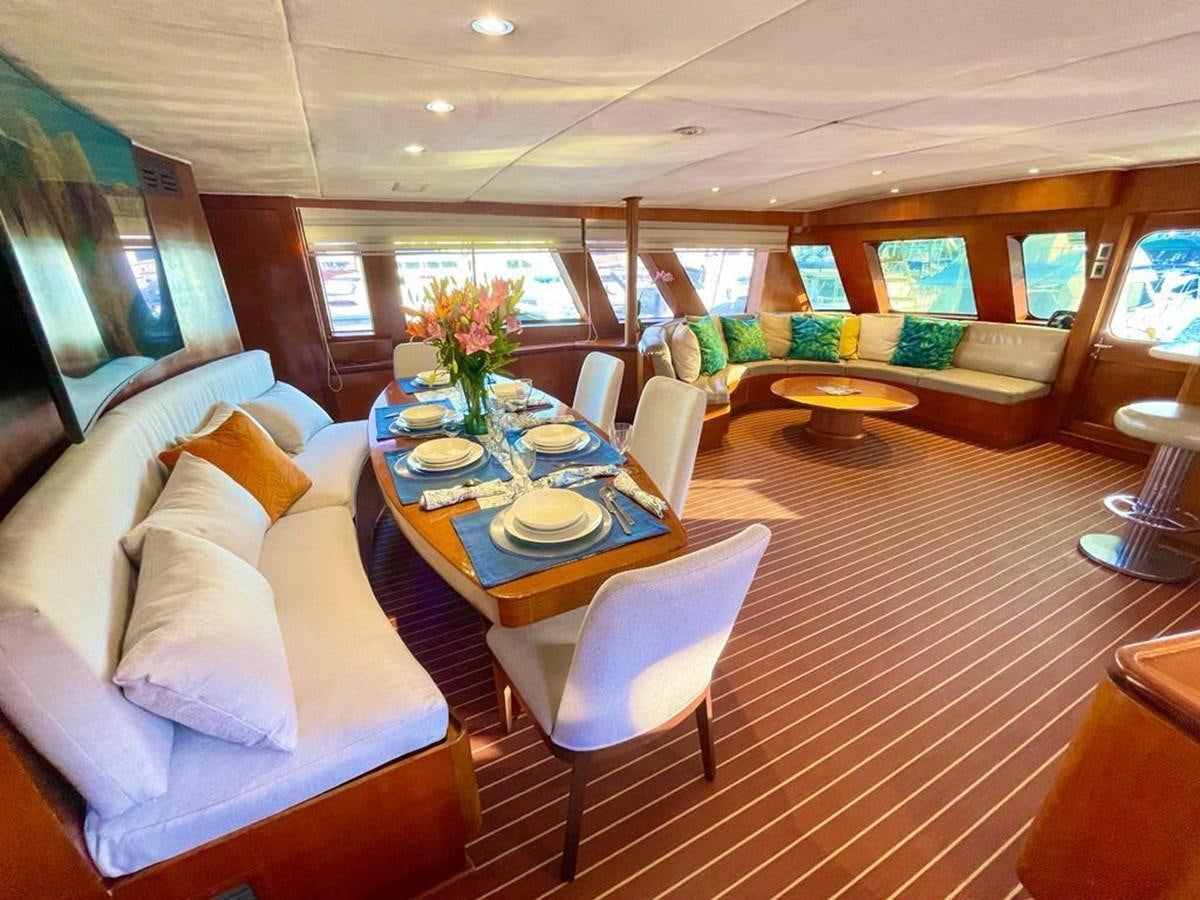 a living room with a couch and a table aboard A NEW BEGINNING Yacht for Sale
