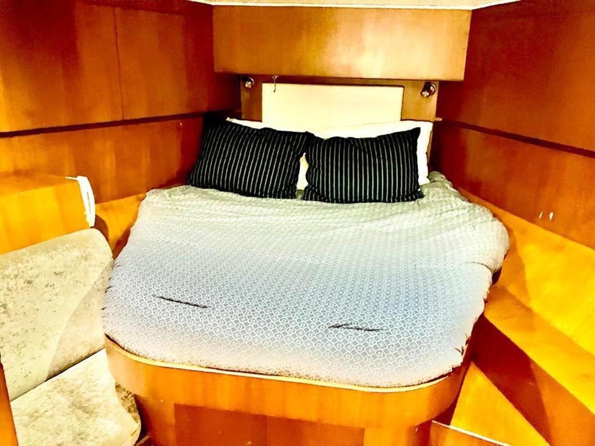 a bed with pillows aboard A NEW BEGINNING Yacht for Sale