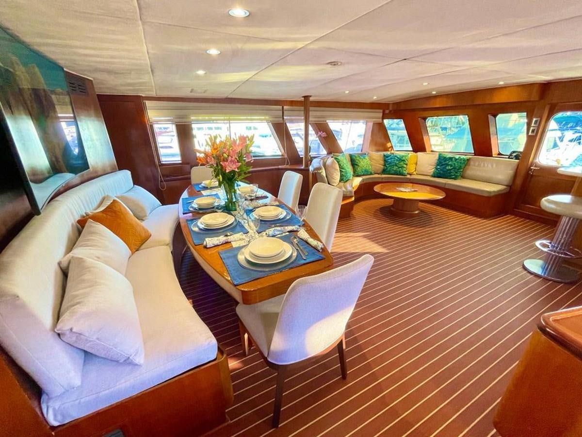 a living room with a couch and a table aboard A NEW BEGINNING Yacht for Sale