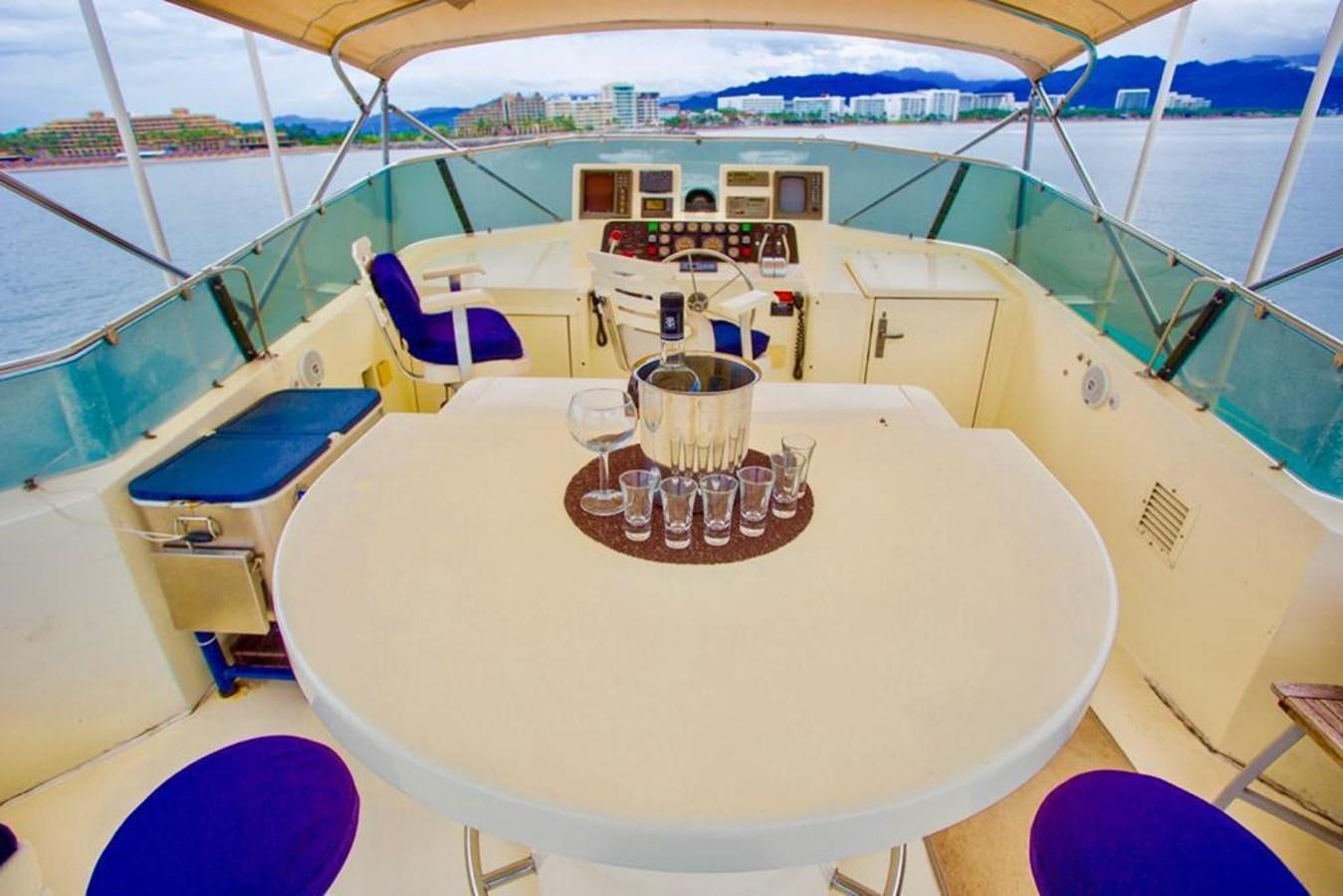 a boat with a table and chairs on it aboard A NEW BEGINNING Yacht for Sale