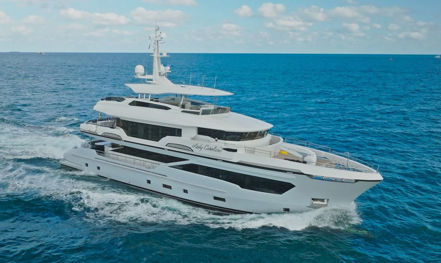 a white yacht in the water aboard KANDO Yacht for Sale