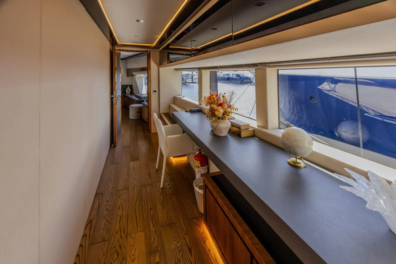a room with a table and chairs aboard KANDO Yacht for Sale