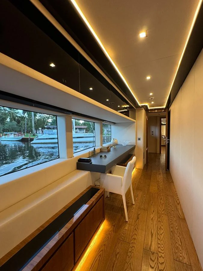 a room with a table and chairs aboard KANDO Yacht for Sale