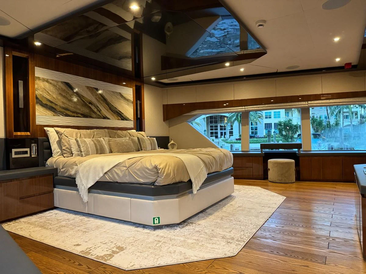 a large bedroom with a large bed aboard KANDO Yacht for Sale