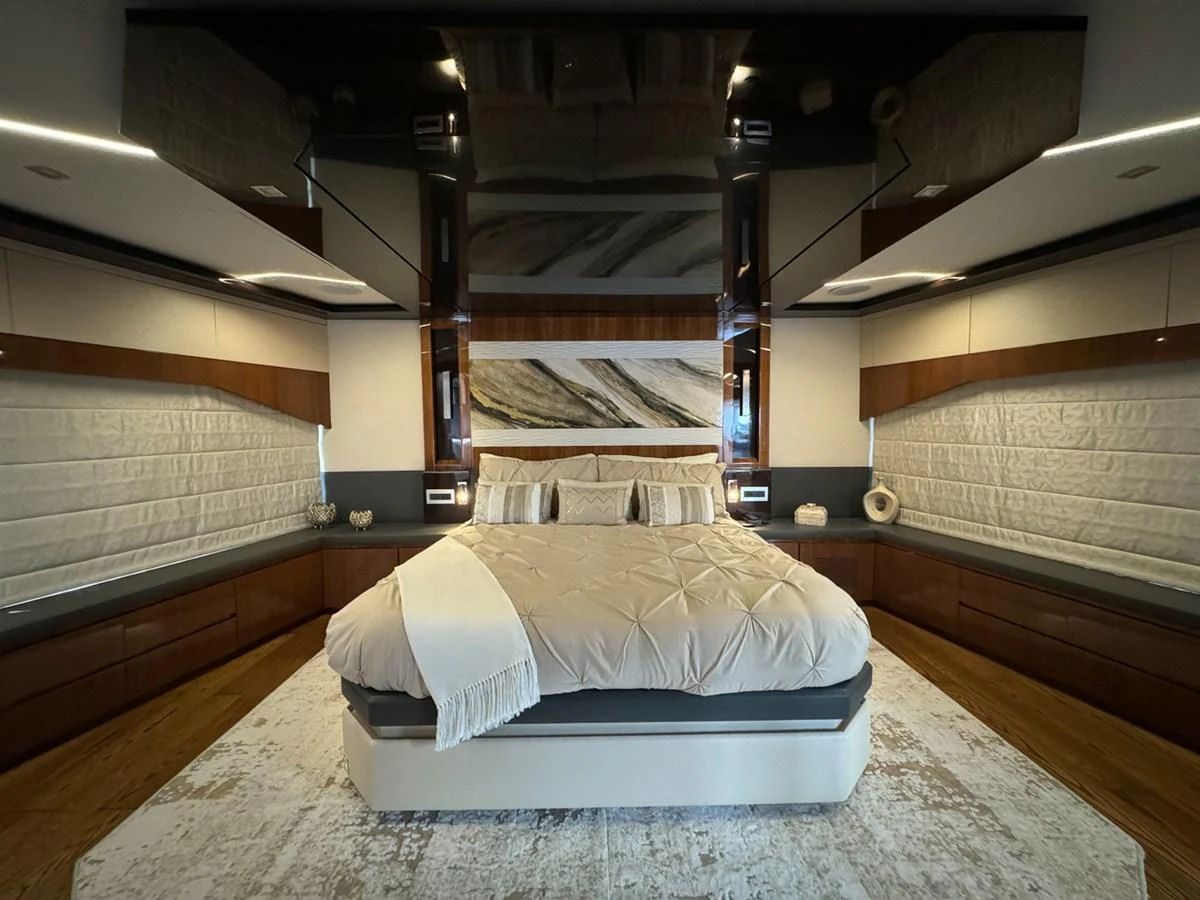 a room with a bed and a large wood wall aboard KANDO Yacht for Sale