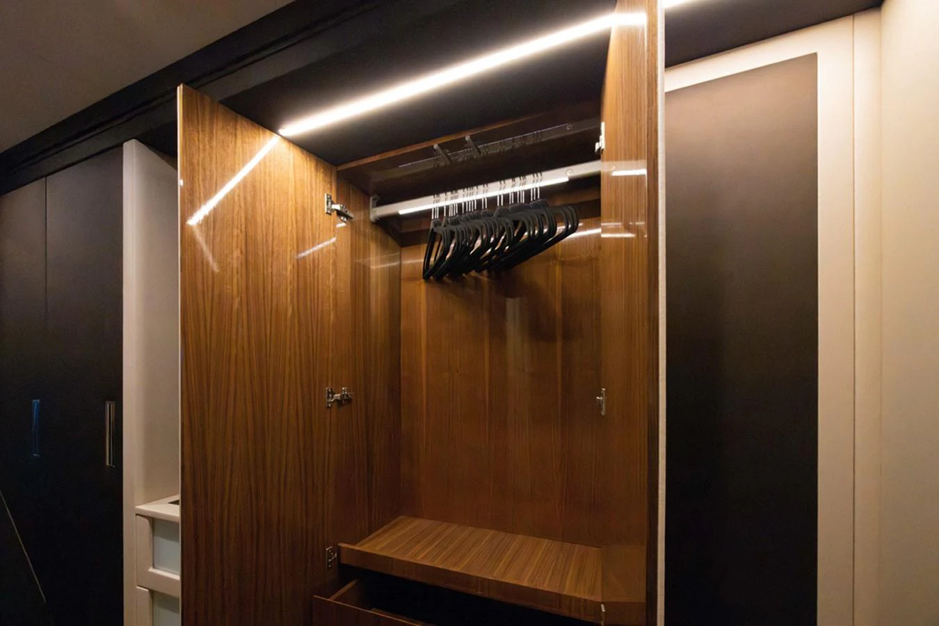 a room with wooden cabinets aboard KANDO Yacht for Sale