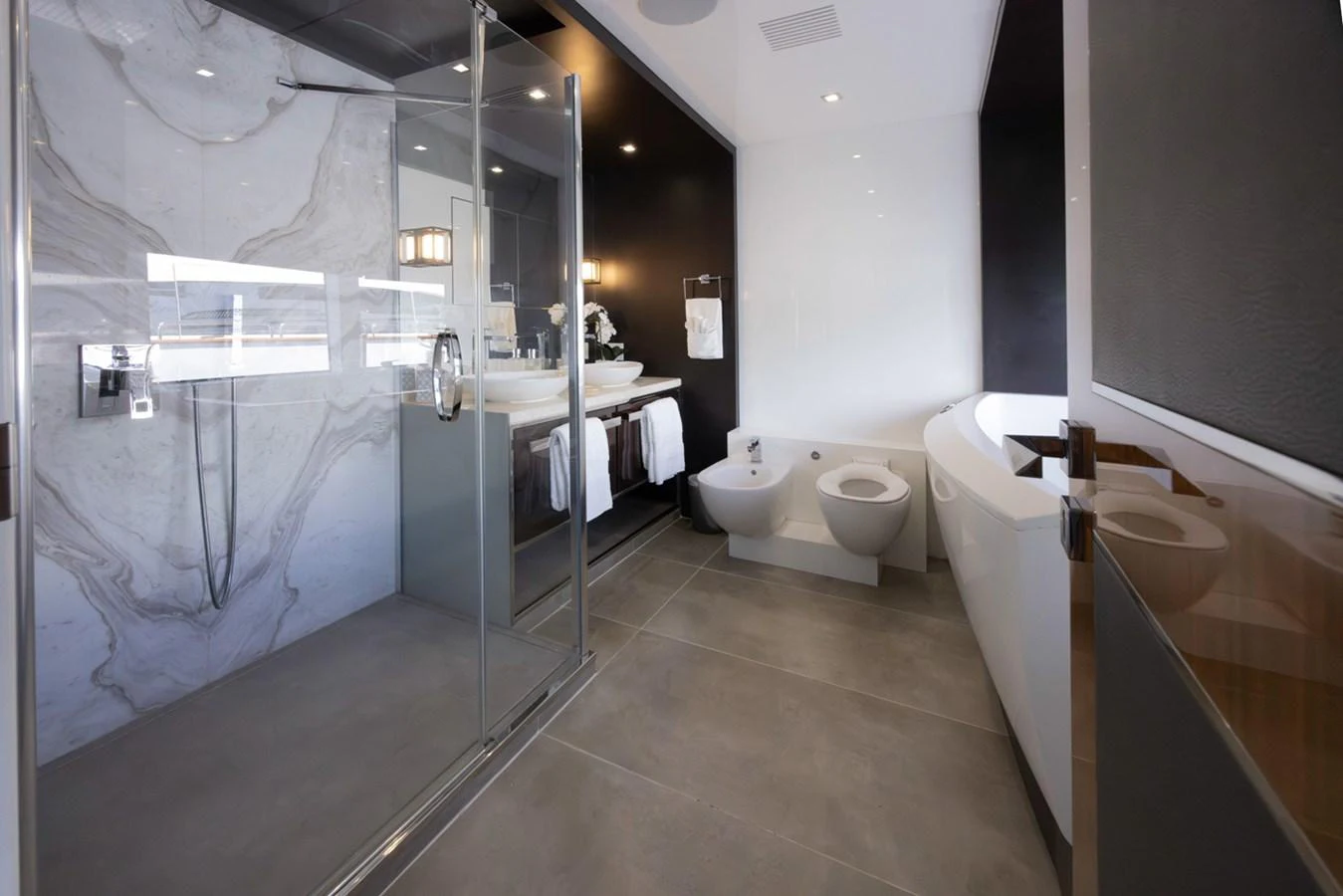 a bathroom with a glass shower aboard KANDO Yacht for Sale