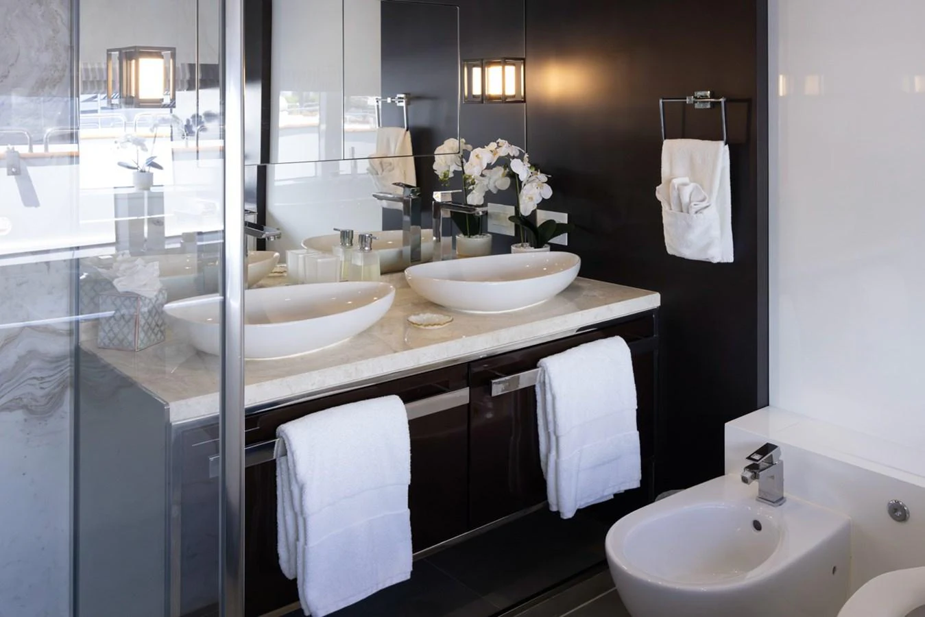 a bathroom with sinks and mirrors aboard KANDO Yacht for Sale