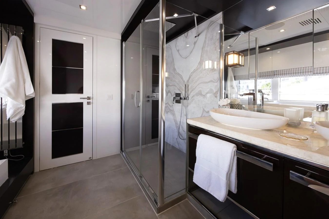a bathroom with a sink and a shower aboard KANDO Yacht for Sale