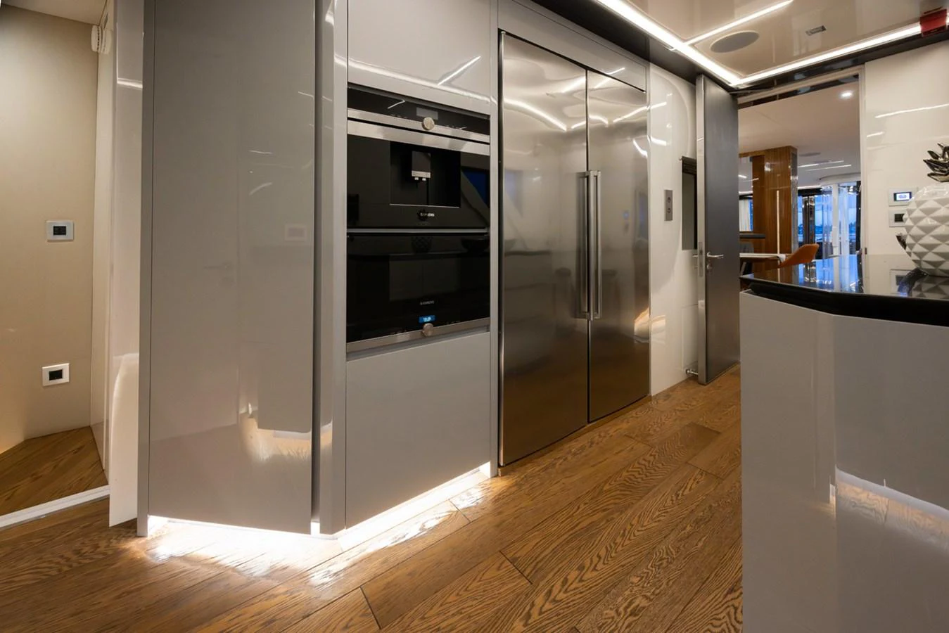 a large silver refrigerator in a room aboard KANDO Yacht for Sale