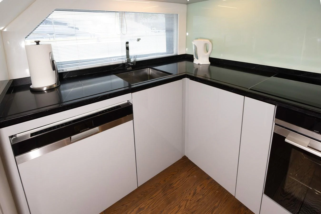 a kitchen with a sink and a window aboard KANDO Yacht for Sale