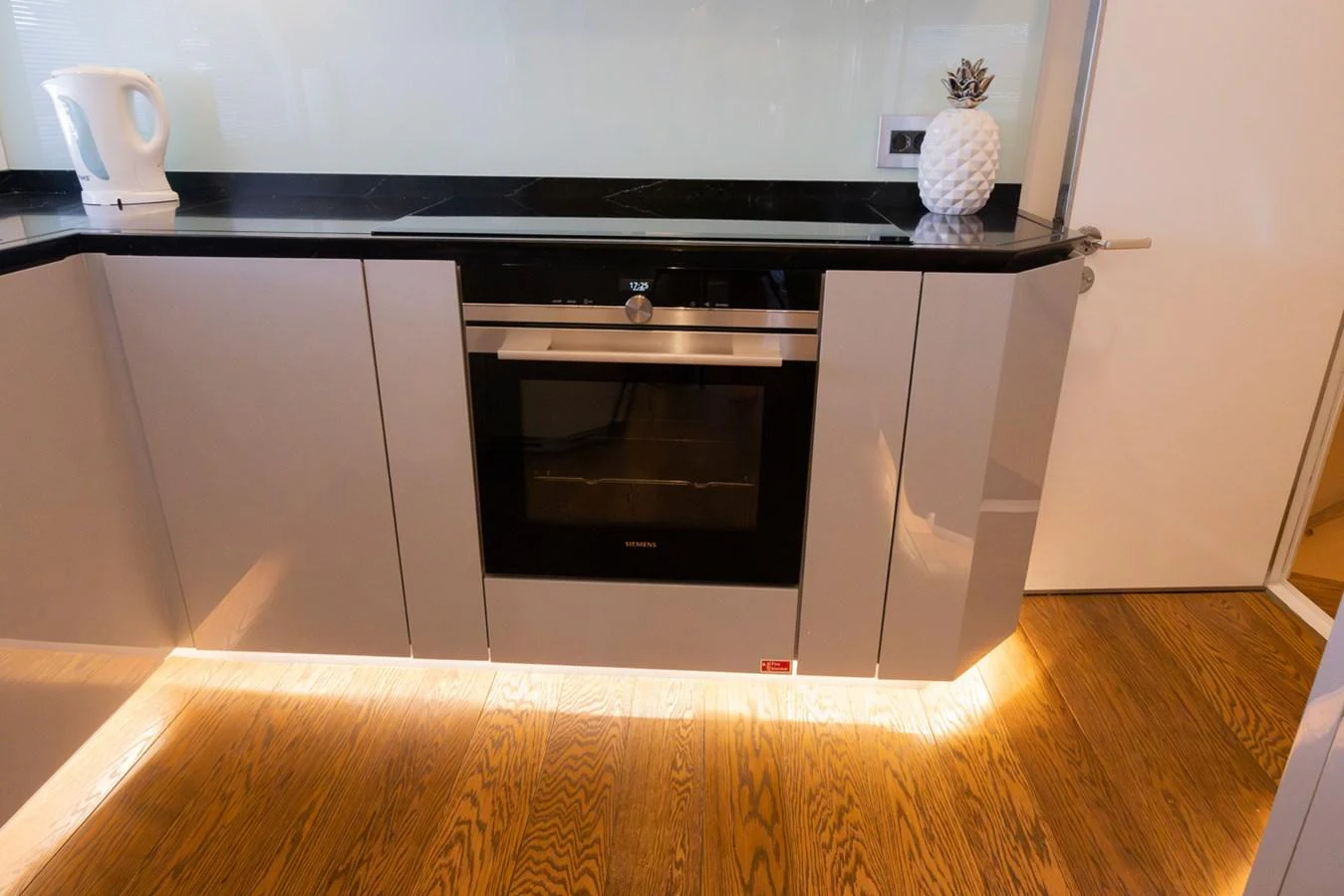 a kitchen with a black stove aboard KANDO Yacht for Sale