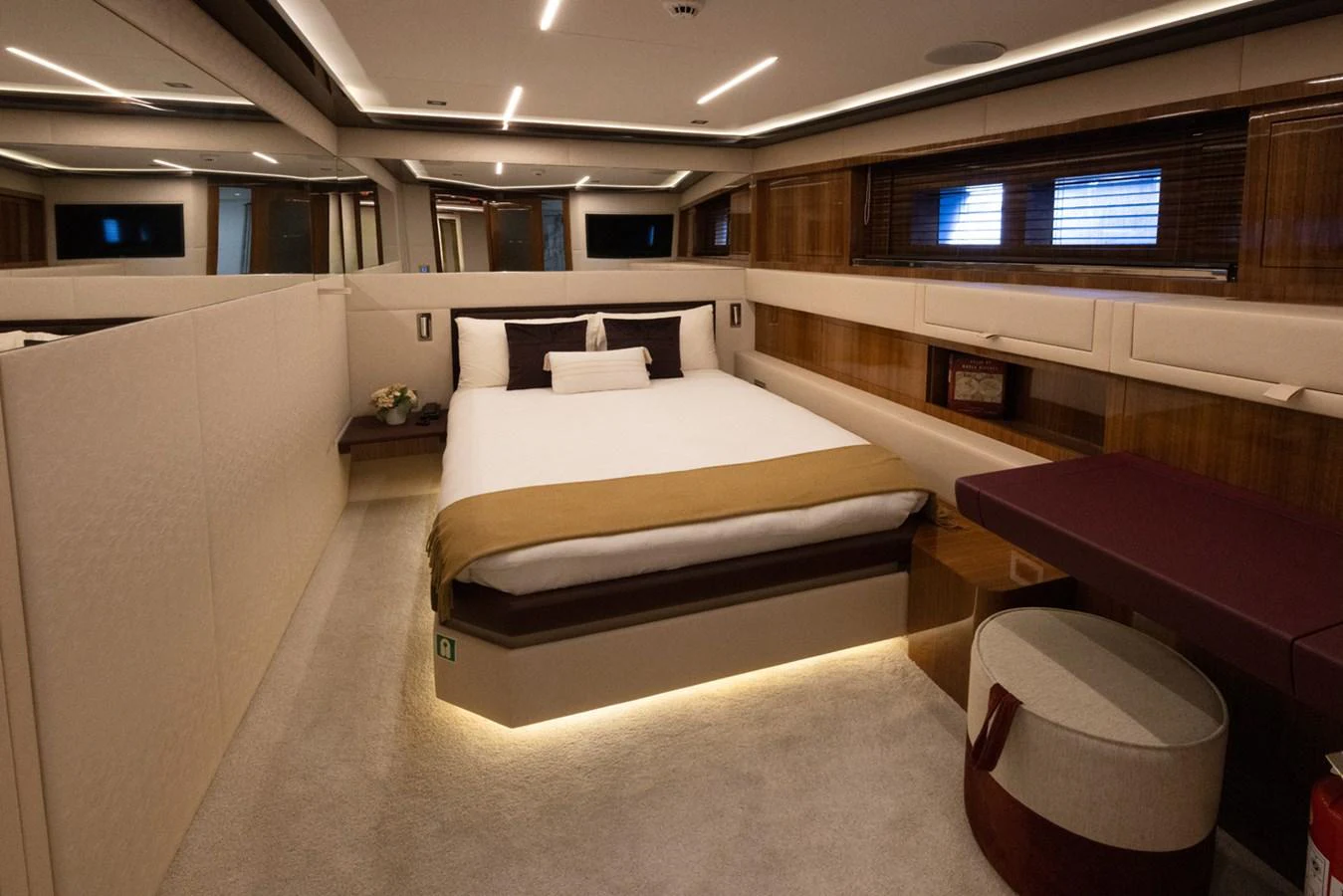 a room with a bed and a table aboard KANDO Yacht for Sale