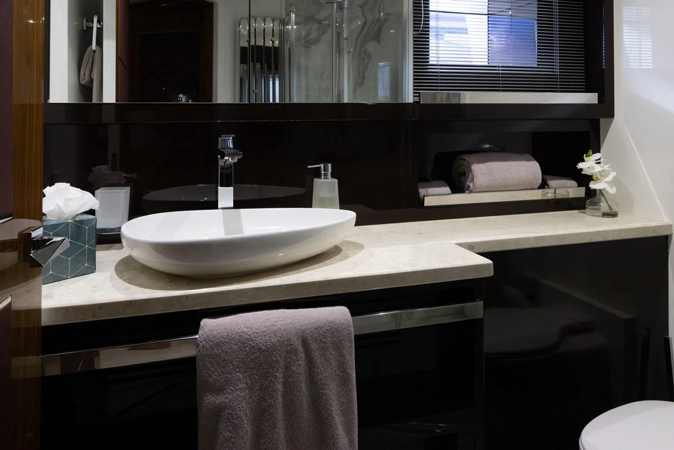 a bathroom with a sink and a mirror aboard KANDO Yacht for Sale