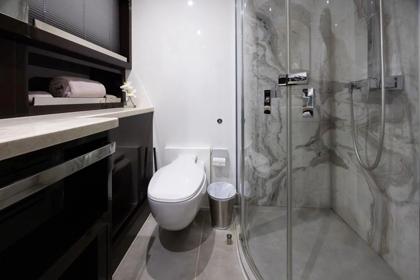 a bathroom with a glass shower aboard KANDO Yacht for Sale