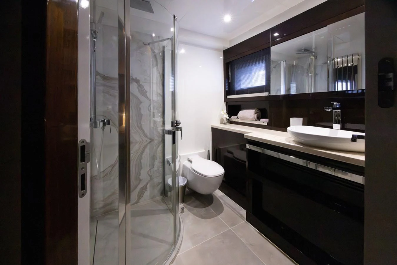 a bathroom with a glass shower aboard KANDO Yacht for Sale